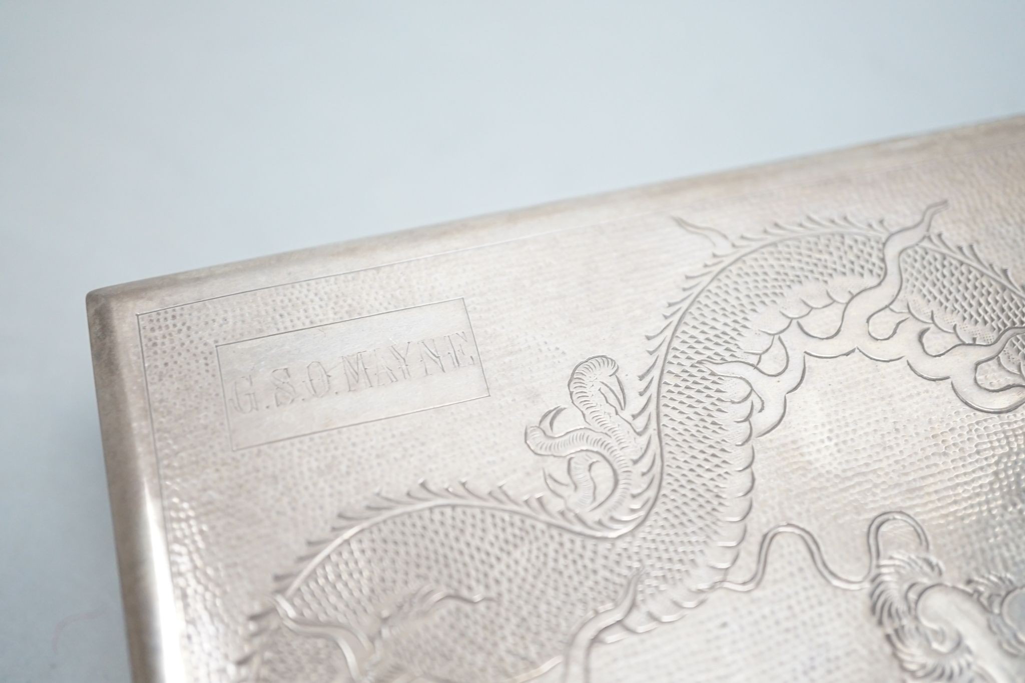 A Chinese Export sterling mounted cigarette box, Lee Yee Hing, engraved with dragon, 17.3cm, gross 18.5oz.
